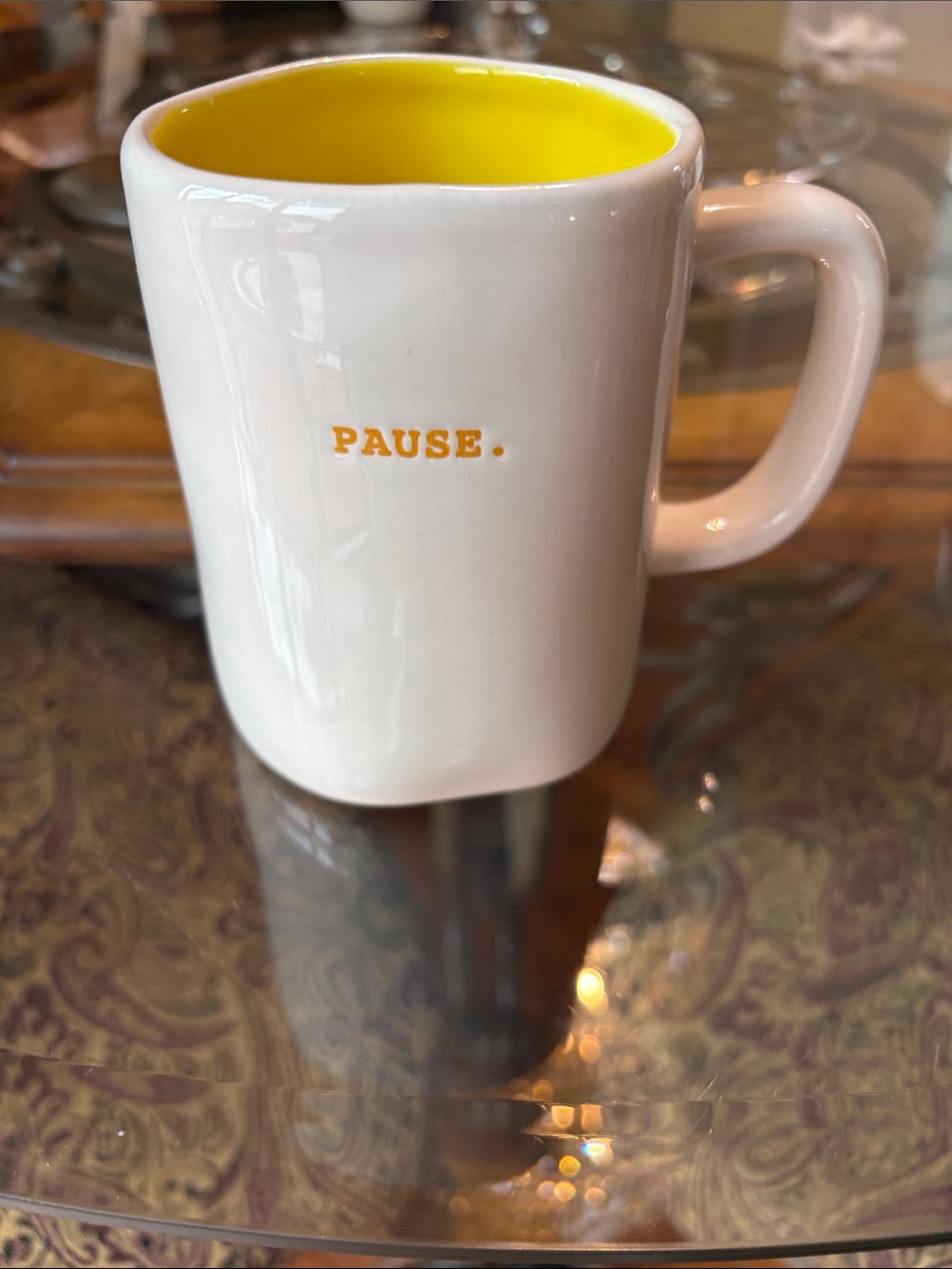 Rae Dunn Artisan Collection mug with a yellow interior and the word "PAUSE."